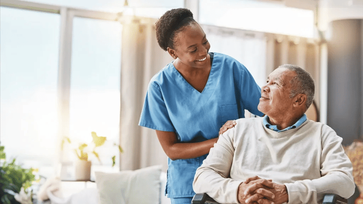 Nurse interacting with a resident in an interior space