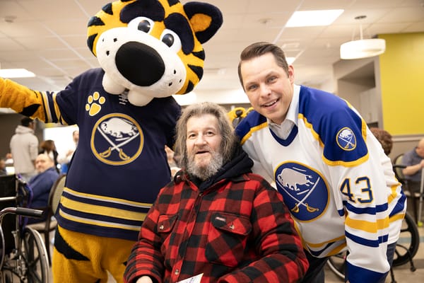 Resident with staff and mascot during an event