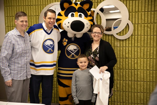 Residents and staff celebrating with a mascot