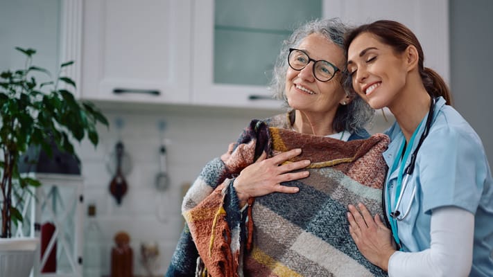 A caregiver and resident sharing a warm moment