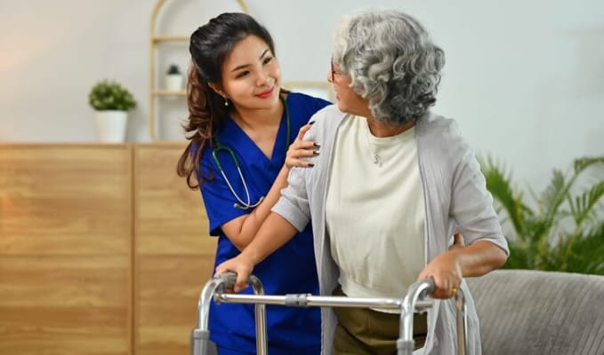 Caregiver assisting resident with walker
