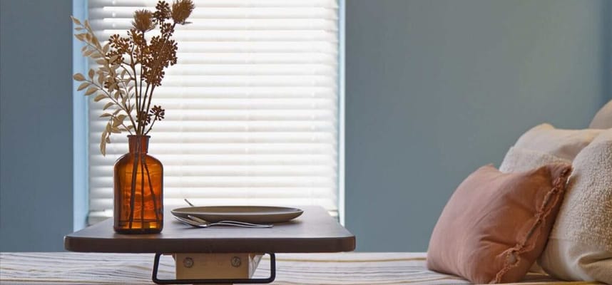 Dining setup with a vase and plate on a table
