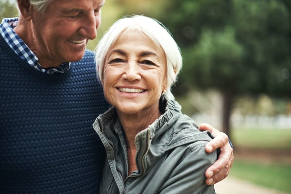 A couple smiling together in a garden