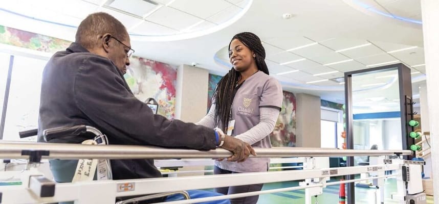 Caregiver assisting a resident in therapy