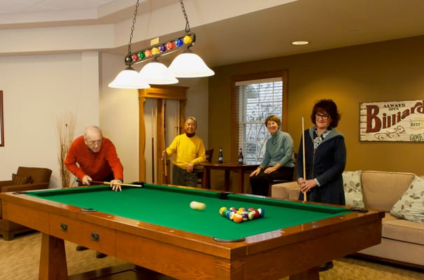 Residents playing billiards in a common area