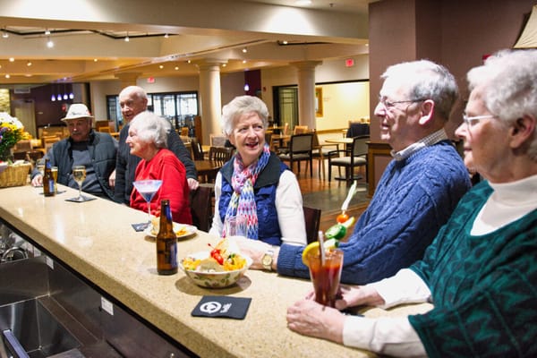 Residents enjoying drinks at the bar in a common area