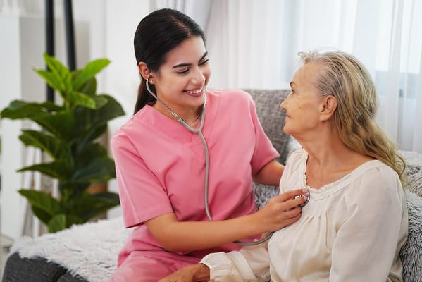 Nurse interacting with a senior resident indoors