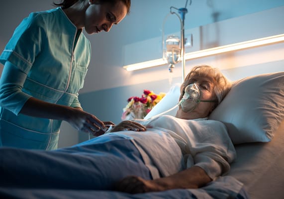 A nurse assists a patient in a medical room