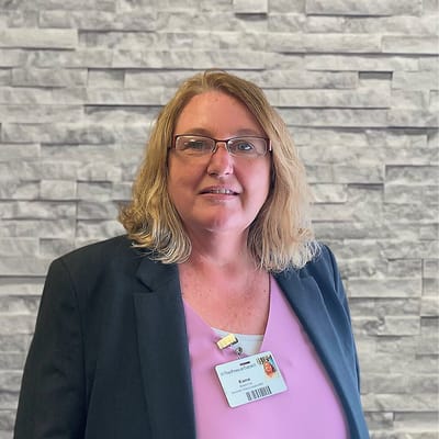 Staff member posing in an interior setting