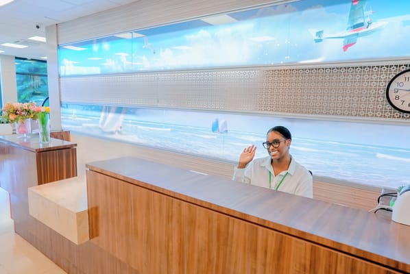 Reception area with a friendly staff member greeting