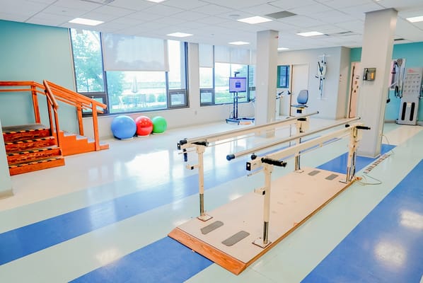Rehabilitation space with exercise equipment and therapy bars