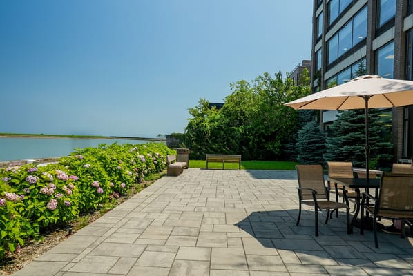 Outdoor patio area with seating and greenery