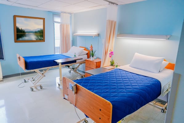 A shared resident room with two beds and decorative elements