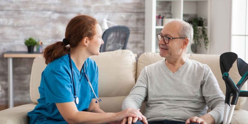 Caregiver and senior resident enjoying a conversation