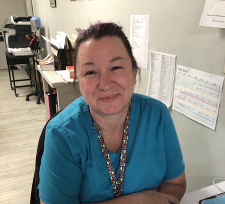 Staff member smiling in a facility office