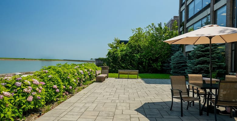Patio area with seating near water.