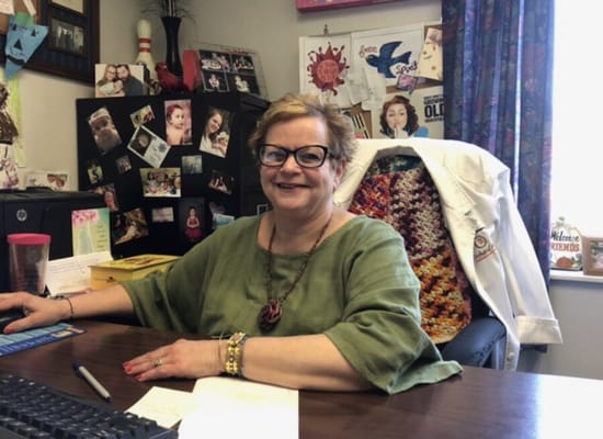 Staff member at her desk in a vibrant office