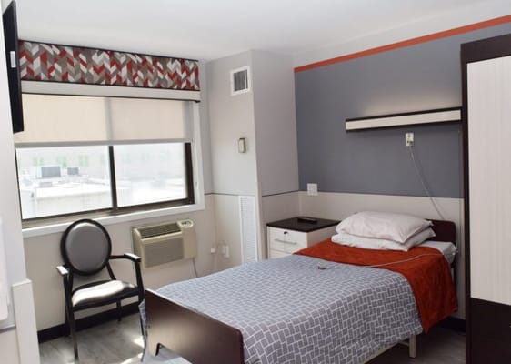 Cozy private room with bed and chair