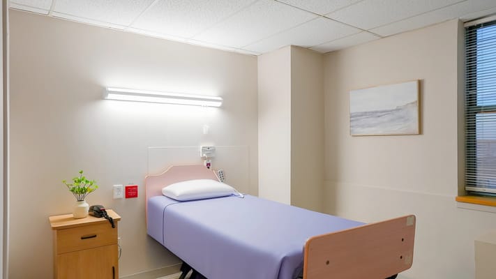 A private resident room with a bed and decor