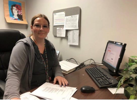 Staff member working at a desk in an office