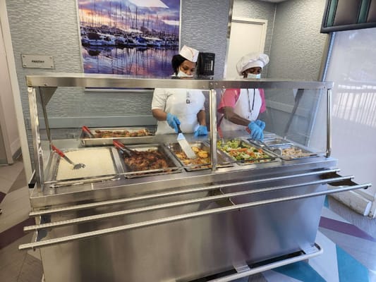 Staff serving food in a dining area