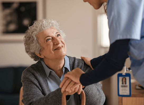 A caregiver interacting with a resident in a warm setting