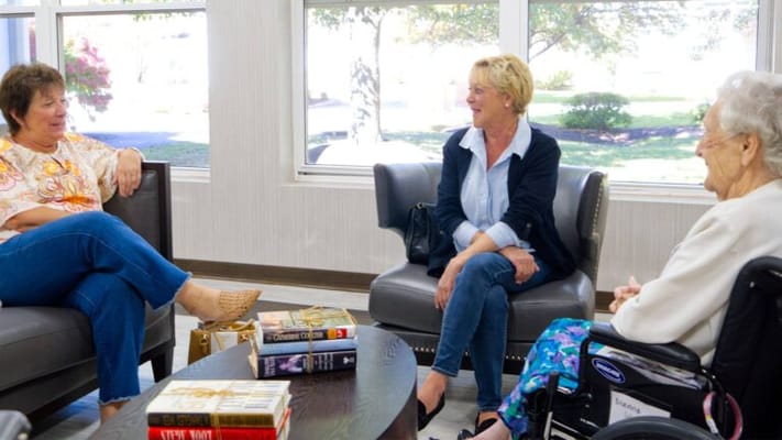 Residents and staff engaging in conversation in a common area