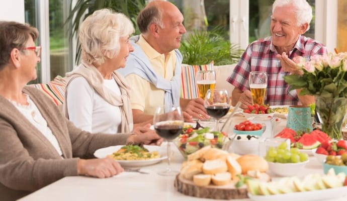 Residents enjoying a meal together at a dining table