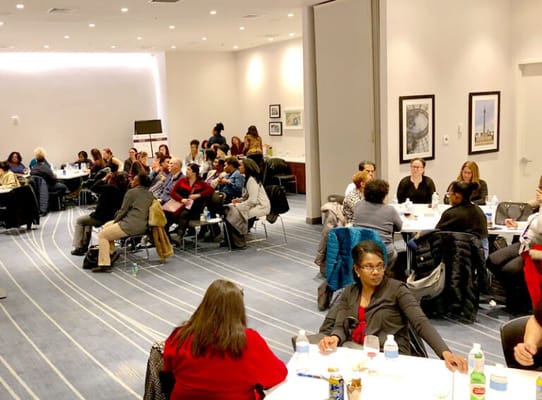 Residents participating in a community meeting in a spacious room