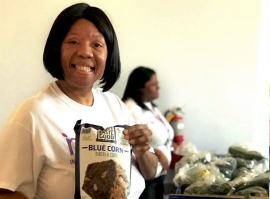 Resident holding a bag of tortilla chips