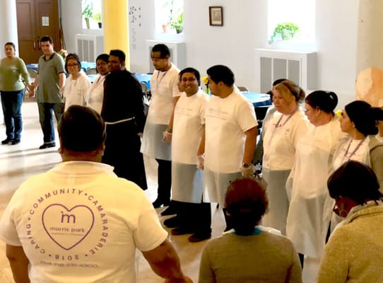 Staff members engaging in a community activity indoors