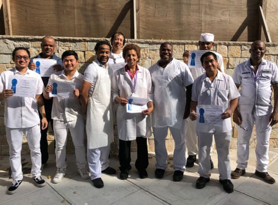 Staff celebrating achievements with certificates