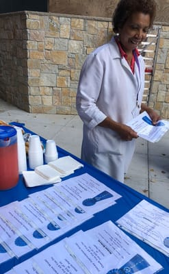 Staff member serving refreshments at a community event