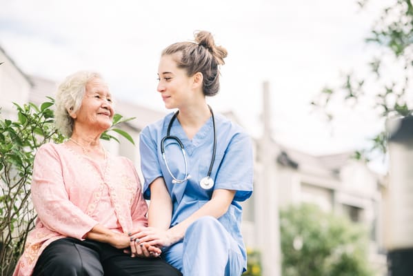 Caregiver and resident sharing a moment outdoors