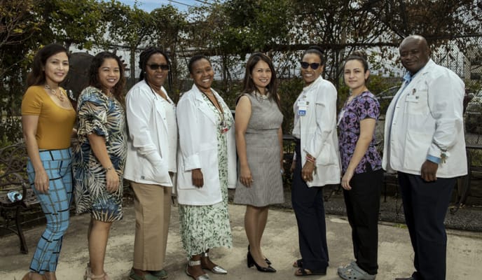 Staff members posing outside in a friendly atmosphere