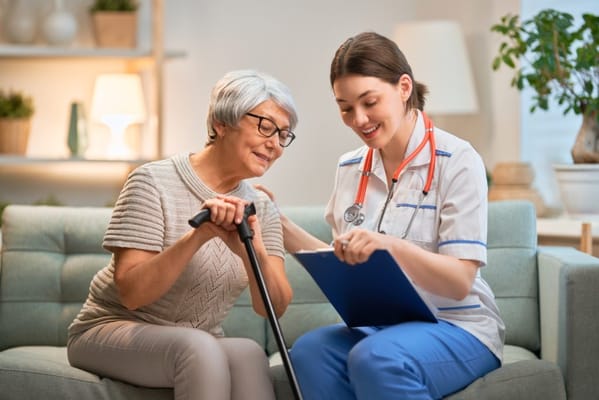 Caregiver assisting a resident with documentation