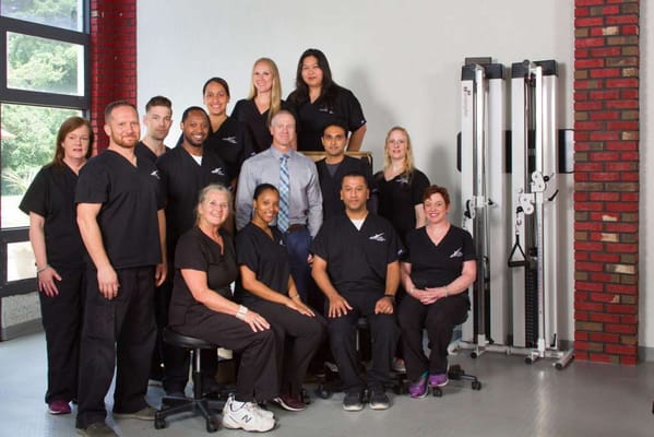 Staff members posing in a facility interior
