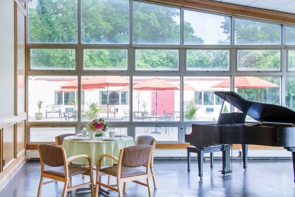 Interior common area with piano and outdoor seating