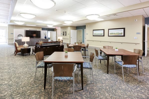 Bright interior view of a common area with tables and chairs