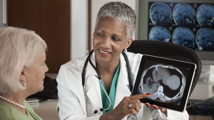 Doctor showing an X-ray to a senior patient