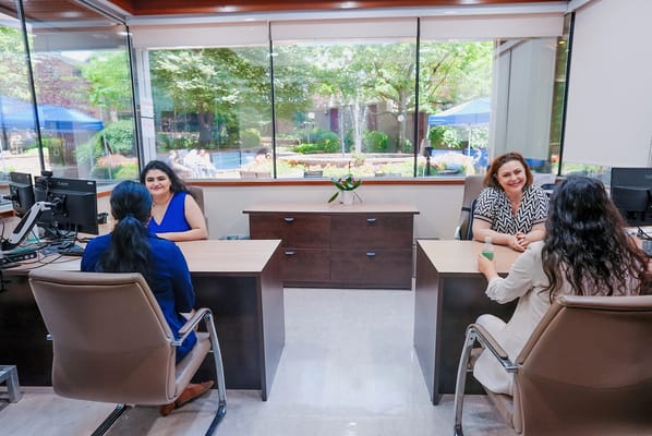 Staff interacting with residents in a welcoming office space