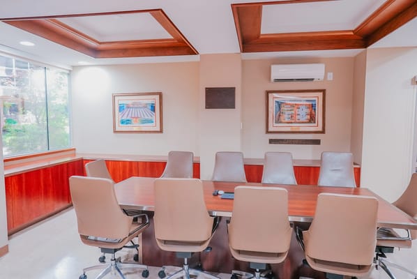 Meeting room with a large wooden table and chairs