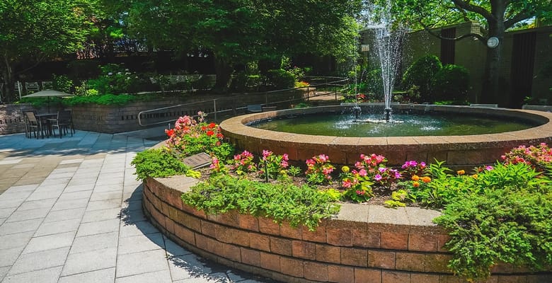 Beautiful outdoor garden with a fountain and flowers