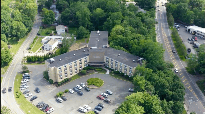 Aerial view of a senior living facility surrounded by trees