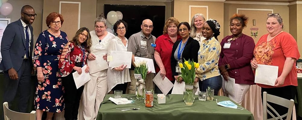 Staff and residents celebrating with certificates