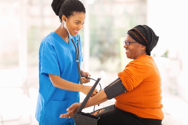 Nurse checking blood pressure of a resident