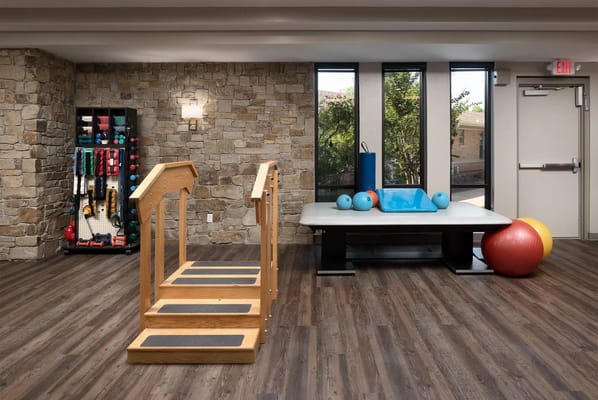 Interior view of a therapy space with exercise equipment