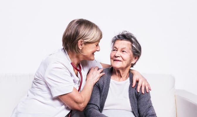 Caregiver interacting warmly with a resident