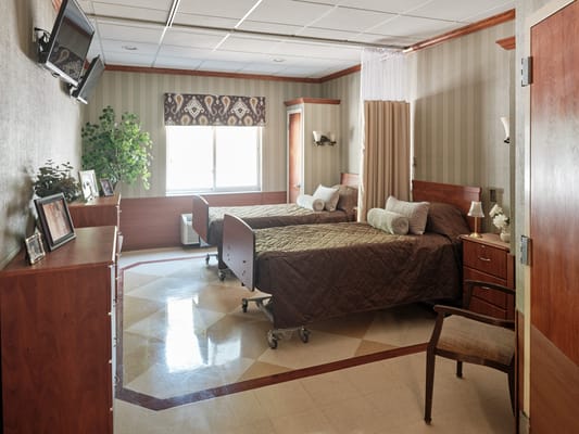 Cozy resident room with two beds and a window