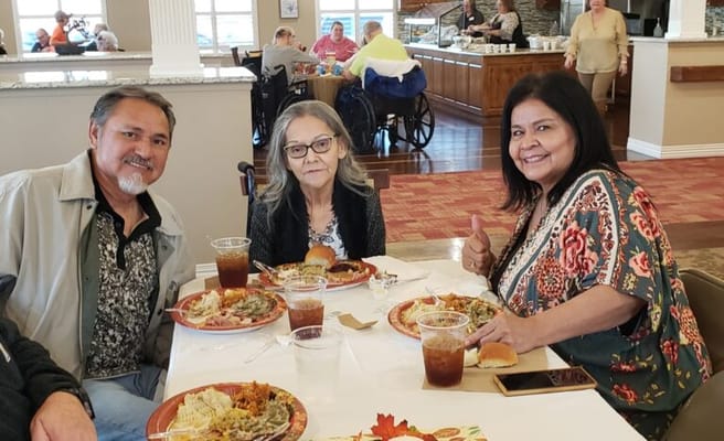 Residents enjoying a meal together in the dining area